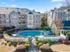 Aerial view of a community pool with surrounding patio and well-manicured landscaping at 4100 Paces Se Walk # 4306, Atlanta, GA 30339
