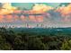 A gorgeous view of the city skyline is set against a backdrop of orange-tinted clouds at sunset at 4100 Paces Se Walk # 4306, Atlanta, GA 30339