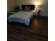 This cozy bedroom features warm wood floors and a comfy bed at 4173 Stillwater Dr, Duluth, GA 30096