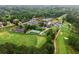 Expansive aerial view showcasing the lush golf course and community amenities, including tennis courts at 575 Indian Hills Pkwy, Marietta, GA 30068