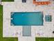 Aerial view of the pool area, showcasing the pool's shape, sunbathing zones, spa, and the surrounding landscaping at 575 Indian Hills Pkwy, Marietta, GA 30068