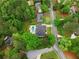 Stunning aerial view of a modern farmhouse with a pool, outdoor kitchen, and lush landscaping at 575 Indian Hills Pkwy, Marietta, GA 30068