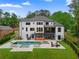 Spacious backyard featuring a pool, outdoor seating, and multi-level deck, perfect for entertaining at 575 Indian Hills Pkwy, Marietta, GA 30068
