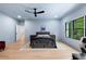 Inviting bedroom featuring hardwood floors, a large window, and a modern ceiling fan for comfort at 575 Indian Hills Pkwy, Marietta, GA 30068