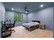 Cozy bedroom with hardwood floors, a ceiling fan, and a backyard view at 575 Indian Hills Pkwy, Marietta, GA 30068