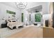 Spacious bedroom features a seating area, a chandelier, large windows with bright, natural light, and stylish decor at 575 Indian Hills Pkwy, Marietta, GA 30068