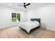 Bright bedroom with hardwood floors, a modern ceiling fan, and a large window offering ample natural light at 575 Indian Hills Pkwy, Marietta, GA 30068