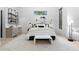 Bright bedroom boasts a wet bar, an elegant rug, a contemporary design, and large windows overlooking the outdoors at 575 Indian Hills Pkwy, Marietta, GA 30068