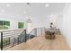 Bright upper dining area illuminated by chandelier, features hardwood floors and backyard view at 575 Indian Hills Pkwy, Marietta, GA 30068