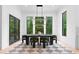 Modern dining room with large windows that provide ample natural light and a view of the surrounding greenery at 575 Indian Hills Pkwy, Marietta, GA 30068