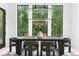 Spacious dining area with modern lighting, stylish chairs, and a view of the surrounding lush greenery at 575 Indian Hills Pkwy, Marietta, GA 30068