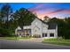 Stunning two-story modern farmhouse with a manicured lawn and three-car garage at twilight at 575 Indian Hills Pkwy, Marietta, GA 30068