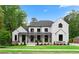 Stunning modern farmhouse with white siding, black trim, and a welcoming front porch perfect for relaxing at 575 Indian Hills Pkwy, Marietta, GA 30068