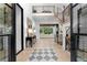 Bright foyer with light hardwood floors, modern staircase, elegant console table, and open-concept living area at 575 Indian Hills Pkwy, Marietta, GA 30068