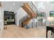 Spacious foyer featuring modern staircase, sleek railing, ample natural light, and a built-in bar area at 575 Indian Hills Pkwy, Marietta, GA 30068
