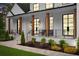 Inviting front porch with wood columns, stone walkway, and lush landscaping at 575 Indian Hills Pkwy, Marietta, GA 30068