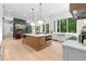 Open kitchen layout with a spacious island, stainless appliances, and views of the living room and backyard at 575 Indian Hills Pkwy, Marietta, GA 30068