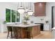 Well-lit kitchen with stainless steel appliances, a central island with seating, and a scenic window overlooking lush greenery at 575 Indian Hills Pkwy, Marietta, GA 30068