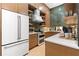 Galley kitchen featuring wood cabinetry, stainless steel appliances and unique vertically stacked tile backsplash at 575 Indian Hills Pkwy, Marietta, GA 30068