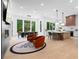 Bright, open kitchen with island, modern appliances, dining area, and decorative rug at 575 Indian Hills Pkwy, Marietta, GA 30068