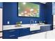 Modern kitchen features dark blue cabinets, a farmhouse sink, white countertops, and stainless steel appliances at 575 Indian Hills Pkwy, Marietta, GA 30068