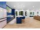Open kitchen concept with modern appliances, a central island with seating, and an adjoining living space at 575 Indian Hills Pkwy, Marietta, GA 30068