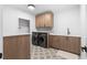 Functional laundry room with modern appliances, storage cabinets, and stylish countertops at 575 Indian Hills Pkwy, Marietta, GA 30068