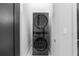 Modern laundry room features gray stacked washer and dryer with white trim at 575 Indian Hills Pkwy, Marietta, GA 30068