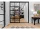 Living room with glass doors, hardwood flooring, and a view of the shelving unit at 575 Indian Hills Pkwy, Marietta, GA 30068