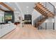 Open-concept living space with hardwood floors, a modern staircase, and fireplace, perfect for entertaining at 575 Indian Hills Pkwy, Marietta, GA 30068