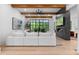 Bright living room features wooden beams, a modern fireplace, sleek TV, and expansive windows with natural light at 575 Indian Hills Pkwy, Marietta, GA 30068