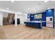 Bright living room boasts wood floors, a modern kitchen with a large island, and a staircase in the background at 575 Indian Hills Pkwy, Marietta, GA 30068