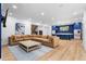 Open-concept living room featuring a large sectional sofa, custom kitchen with island, and sleek, modern finishes at 575 Indian Hills Pkwy, Marietta, GA 30068
