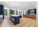 Open-concept living room featuring a kitchen island with barstool seating and a comfortable lounge area with sofa at 575 Indian Hills Pkwy, Marietta, GA 30068