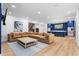 Open-concept living room featuring a large sectional sofa, custom kitchen with island, and sleek, modern finishes at 575 Indian Hills Pkwy, Marietta, GA 30068