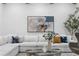 Bright living room with sectional sofa, modern art, and tree accent at 575 Indian Hills Pkwy, Marietta, GA 30068