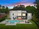 Stunning rear exterior view of the modern home, featuring a pool, spa, patio, and outdoor entertaining area at 575 Indian Hills Pkwy, Marietta, GA 30068