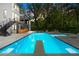 Back yard swimming pool with diving board and lounge chairs with built-in spa, perfect for summer relaxation at 575 Indian Hills Pkwy, Marietta, GA 30068