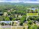 Expansive aerial view showcasing the property's location, surrounding greenery, and outbuildings at 5855 Willis Ln, Cumming, GA 30040