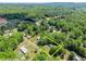 Wide aerial shot highlighting the property lines, structures, and lush landscape at 5855 Willis Ln, Cumming, GA 30040