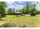 Spacious backyard featuring green grass and a large storage shed for all your outdoor needs at 5855 Willis Ln, Cumming, GA 30040