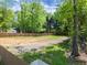 View of wooded backyard with brown fence at 5855 Willis Ln, Cumming, GA 30040