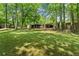 Large lot showcasing the expansive green space and mature trees surrounding the property at 5855 Willis Ln, Cumming, GA 30040