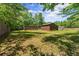 Large backyard area with storage sheds, offering ample space and privacy for outdoor enjoyment at 5855 Willis Ln, Cumming, GA 30040