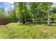 Lush green backyard with mature trees providing shade, perfect for outdoor activities and relaxation at 5855 Willis Ln, Cumming, GA 30040