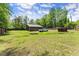 Expansive backyard featuring green grass and a large storage shed for all your outdoor needs at 5855 Willis Ln, Cumming, GA 30040
