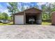 Spacious barn with garage door and covered RV storage area for protecting vehicles from the elements at 5855 Willis Ln, Cumming, GA 30040