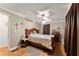 Cozy bedroom features wood floors, a ceiling fan, and traditional decor, creating a warm and inviting space at 5855 Willis Ln, Cumming, GA 30040