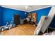 Spacious bedroom with hardwood floors and bright blue walls, perfect for a room at 5855 Willis Ln, Cumming, GA 30040