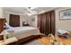 Comfortable bedroom with ceiling fan, hardwood floors, and ample natural light from the windows at 5855 Willis Ln, Cumming, GA 30040